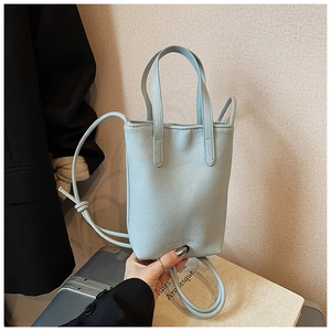 Close-up of light blue mini tote bag with litchi texture and Sweet Color embossing