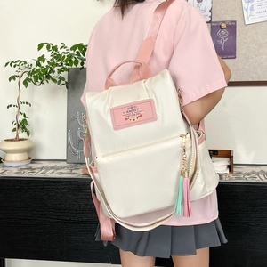 Sac à dos en tissu Oxford imperméable pour femmes avec bretelles roses et charm à pompon