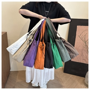 Multi-color nylon tote bags with drawstring closure displayed in various vibrant shades