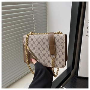 Close-up of beige geometric pattern crossbody bag with brown leather and gold chain