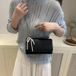 Minimalist black woven handbag with pearl bow and silver metal handle for women