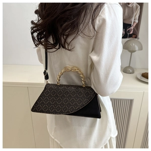 Detail of vintage leopard print crossbody bag with gold twisted handle and black leather base