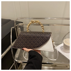 Detail of a leopard monogram flap and white leather bag with golden spiral handle
