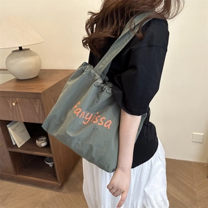 Green nylon tote bag with orange Fanyissa print and drawstring, casual shoulder style