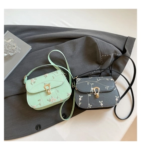 Detail of floral lace embroidery and gold U-shaped buckle on small crossbody bags