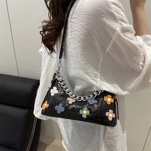 Black crocodile embossed leather underarm bag with colorful plush flowers and silver chain