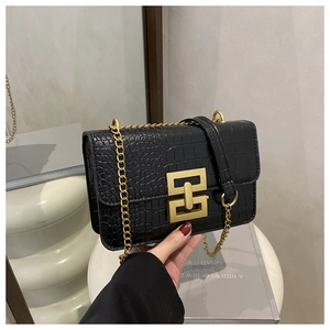 Detail of black crocodile texture PU leather crossbody bag with gold geometric metal buckle