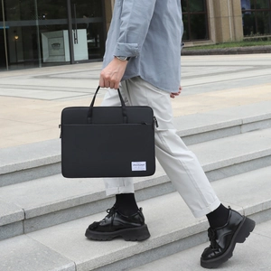 Slim black nylon business laptop briefcase with reinforced handle and exterior zipper pocket