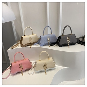 Showcase of textured handbags in five colors with gold S-logo and wave-shaped base