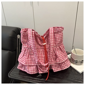Detailed view of pink gingham tote bag with layered ruffle design and drawstring closure