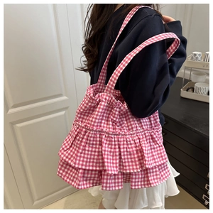 Detailed side view of pink and white gingham tote bag with layered ruffle design