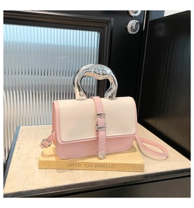 Close-up of pink and beige patchwork bag with a modern silver liquid metal handle