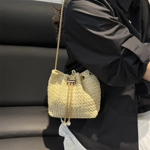 Fashionable woven bucket bag with gold chain strap and pearl drawstring details