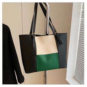 Detail of tricolor leather tote bag with adjustable straps and geometric patchwork design
