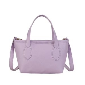Minimalist purple lychee leather bucket bag with top handles and adjustable shoulder strap