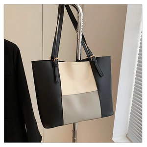 Detail view of large color-block tote bag in black beige and grey premium synthetic leather
