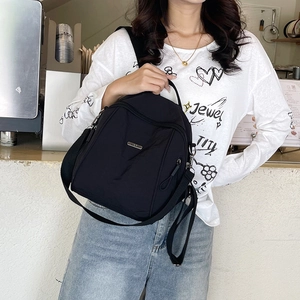 Fashionable black nylon backpack with multiple pockets for commuting and travel use