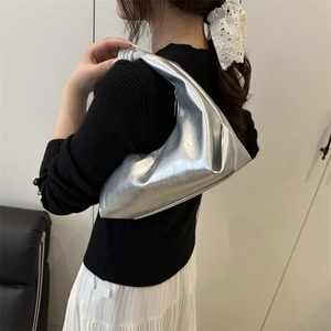 Minimalist silver crescent shoulder bag with pleated texture and stylish knotted handle