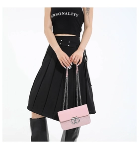 Close-up of pink chain bag with glitter panel and silver double ring metal buckle lock
