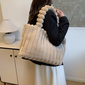 Chic beige plush tote bag with vertical pleated texture and fuzzy beaded handle detail
