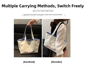 Versatile cream canvas tote bag with red lettering and blue striped lining detail