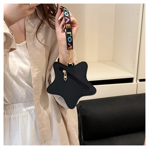 Close-up of black star-shaped coin purse with litchi texture and LOVE strap