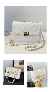 Macro detail of white quilted crossbody bag with gold hardware and chain strap