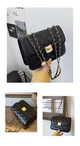 Detail view of black quilted crossbody bag with golden chain strap and ball adjustment buckle