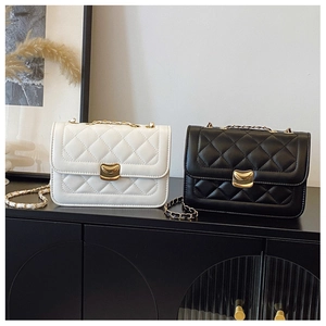 Quilted flap crossbody bags in black and beige with crescent gold metal clasps