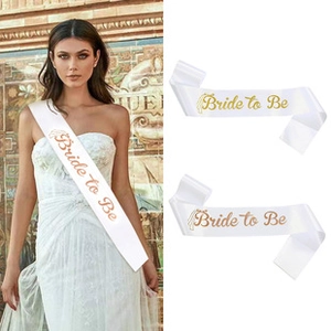 Detail of white satin Bride to Be sash with gold glitter lettering for bachelorette parties