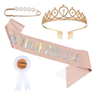 Close-up of birthday party set with pink glitter sash and crystal tiara headband