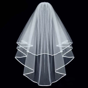 Detail of white double-layered bridal veil with smooth satin ribbon edge finish