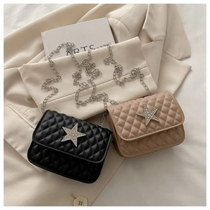 Détail de mini sacs carrés matelassés avec étoiles en strass et bandoulières en chaîne