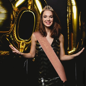 Close-up of sparkling crystal birthday tiara and Birthday Princess rose gold glitter sash