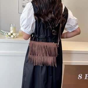 Brown faux suede shoulder bag with tassel fringe detail and adjustable strap