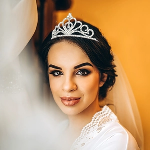 Elegant silver bridal tiara crown with sparkling crystals worn by a beautiful model