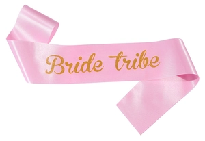 Detail of pink satin Bride Tribe sash with golden glitter lettering for bridal parties