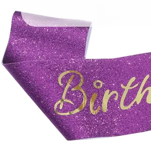 Detail of purple glitter birthday sash with premium gold foil stamping text texture