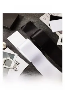 Macro shot of high-density double-sided white satin fabric with smooth silk finish
