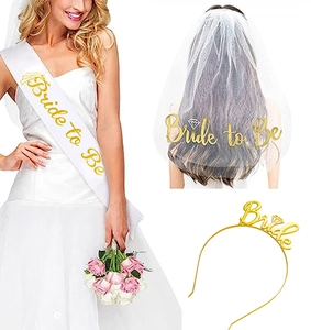 Close-up of white satin Bride to Be sash, glitter veil, and golden metal bride headband set