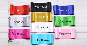 Macro view of silky satin sashes in various colors with shiny smooth texture detail