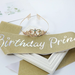 Detailed shot of a gold heart crown with colorful crystals and Birthday Princess sash