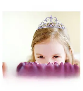 Detail of silver alloy crown with purple crystals worn by a child at a birthday party