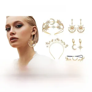 Close-up of Bohemian gold sun and moon earrings with sparkling crystal star details