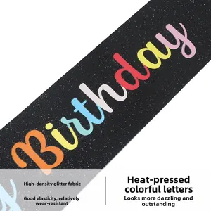 Detailed macro view of black glitter fabric birthday sash with colorful heat transfer text
