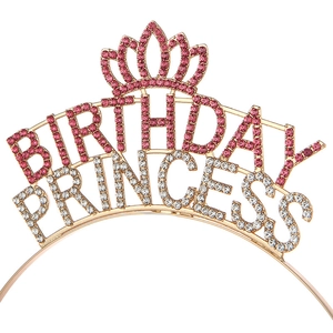 Detail of golden metal crown headband with pink rhinestones spelling BIRTHDAY PRINCESS