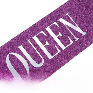 Close-up of purple glitter fabric sash with silver metallic QUEEN lettering detail