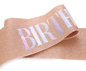 Macro shot of rose gold glitter birthday sash with holographic lettering detail