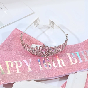 Close-up of pink 16th birthday sash and silver crown with pink rhinestones