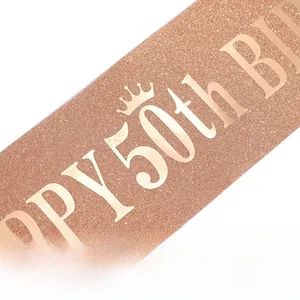 Detail of rose gold glitter sash with metallic Happy 50th Birthday text and crown